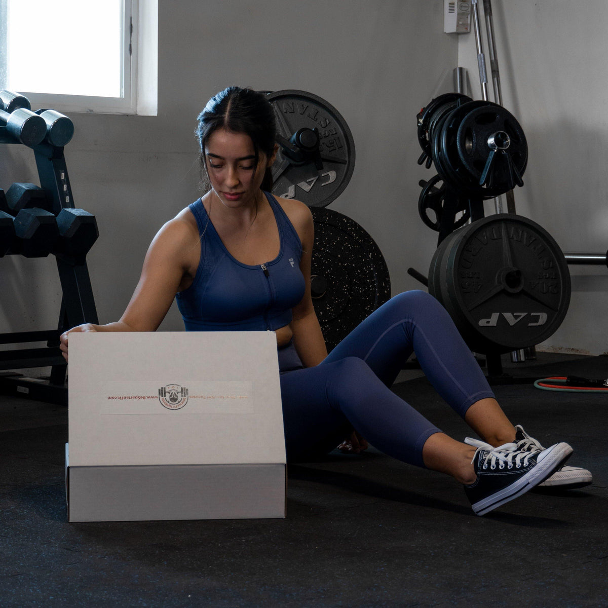 Personal Trainer exploring Home Gym Kit products at training facility. 
